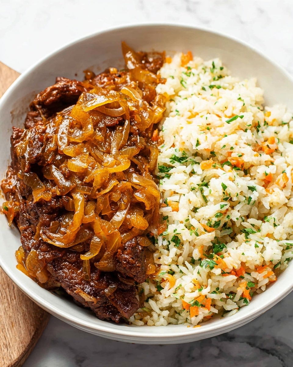 A white bowl holds two layers of food side by side. On the left, a thick layer of dark brown cooked meat is topped with a glossy, golden-brown onion sauce with visible cooked onion slices covering the meat. On the right, there is a thick, even layer of cooked white rice mixed with small bits of orange carrot and green herbs, giving it a soft texture. The bowl sits on a white marbled surface. Photo taken with an iphone --ar 4:5 --v 7