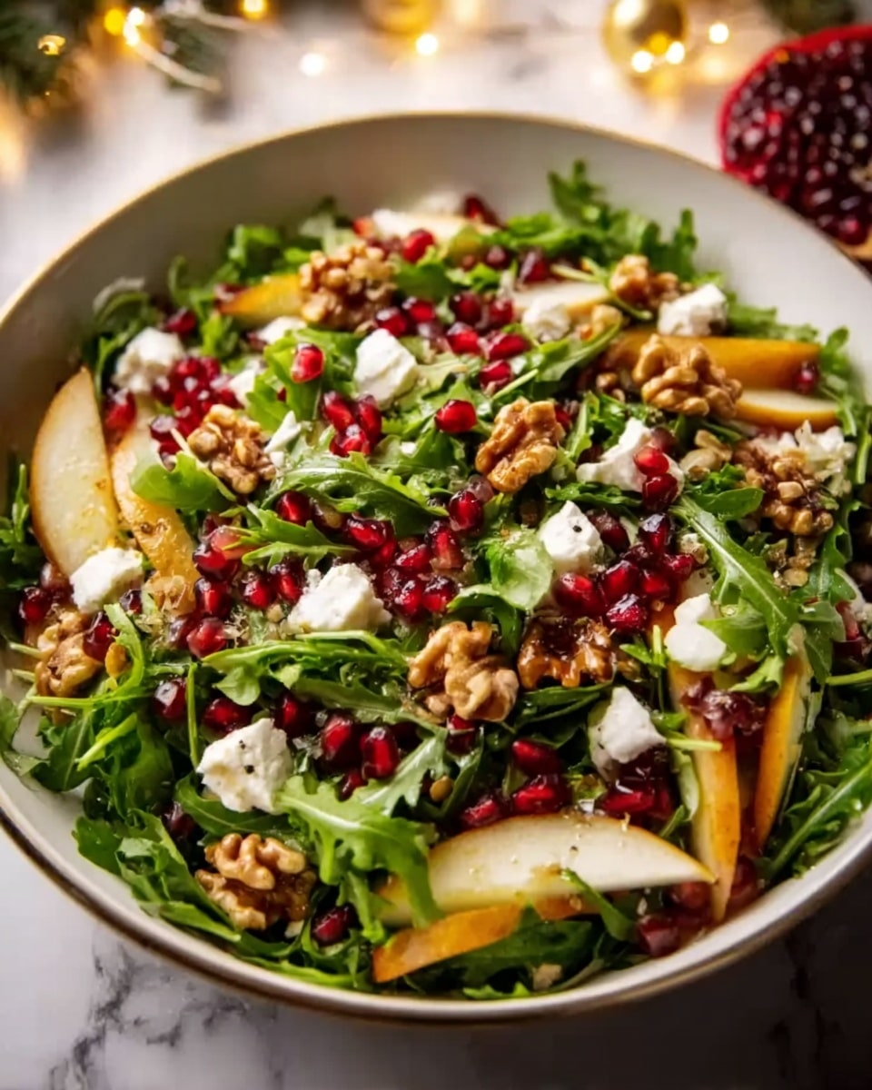 A white bowl filled with a fresh salad that has layers of green arugula leaves forming the base. On top, bright red pomegranate seeds are scattered evenly, adding small pops of color. Thin, light yellow slices of pear are spread around the bowl, partially covered by chopped, golden brown walnuts that add texture. Small chunks of creamy white cheese are sprinkled throughout, and the whole salad looks glossy from a light dressing. The bowl is placed on a white marbled surface with soft warm lights in the background. Photo taken with an iphone --ar 4:5 --v 7