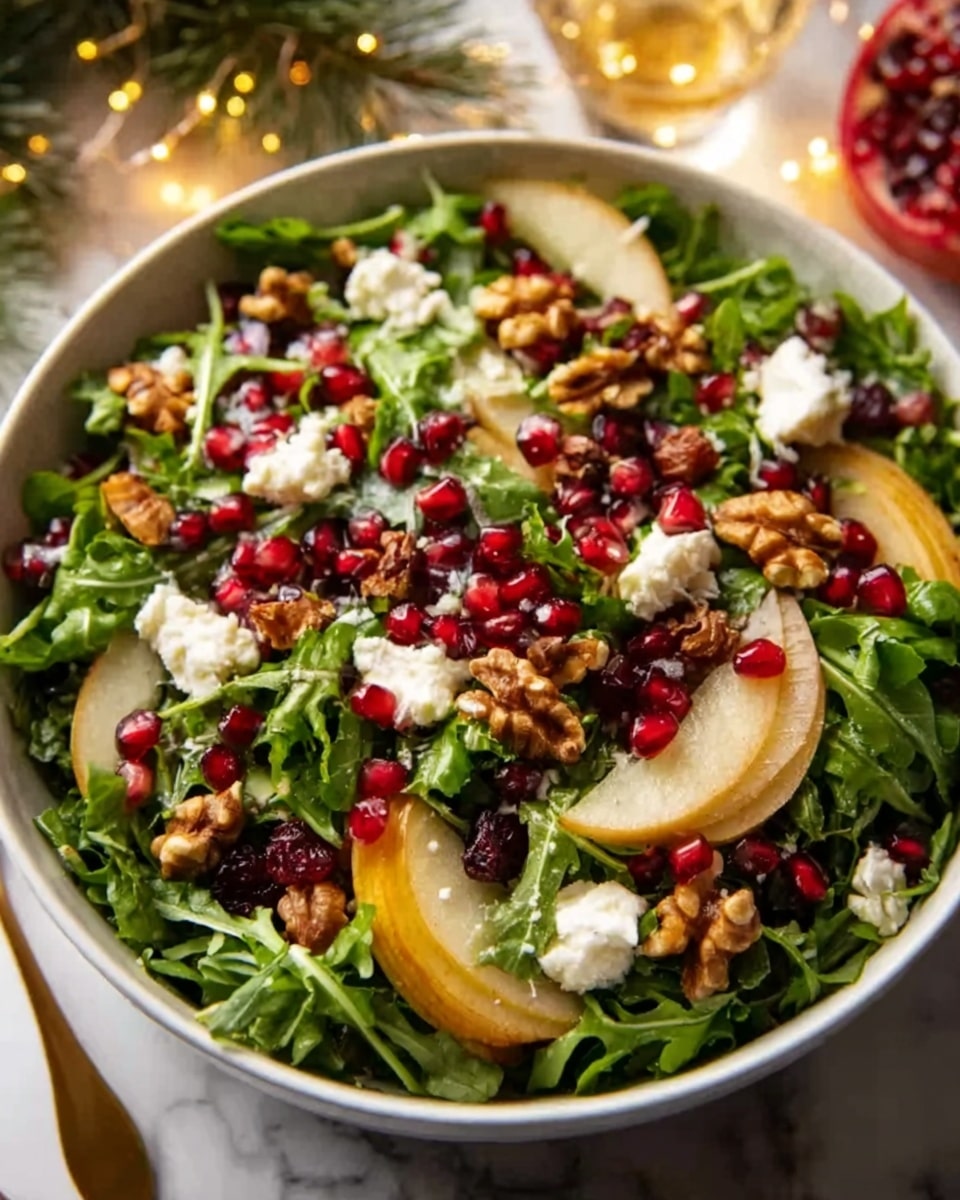 A large white bowl filled with a fresh, colorful salad. The bottom layer is dark green arugula leaves, topped with scattered bright red pomegranate seeds and crunchy light brown walnut pieces. Thin, pale yellow slices of pear are spread evenly over the salad, with small dollops of creamy soft white cheese placed around. The textures range from leafy greens to juicy fruit, crunchy nuts, and smooth cheese. The bowl sits on a white marbled surface with warm holiday lights and decorations blurred softly in the background. Photo taken with an iphone --ar 4:5 --v 7