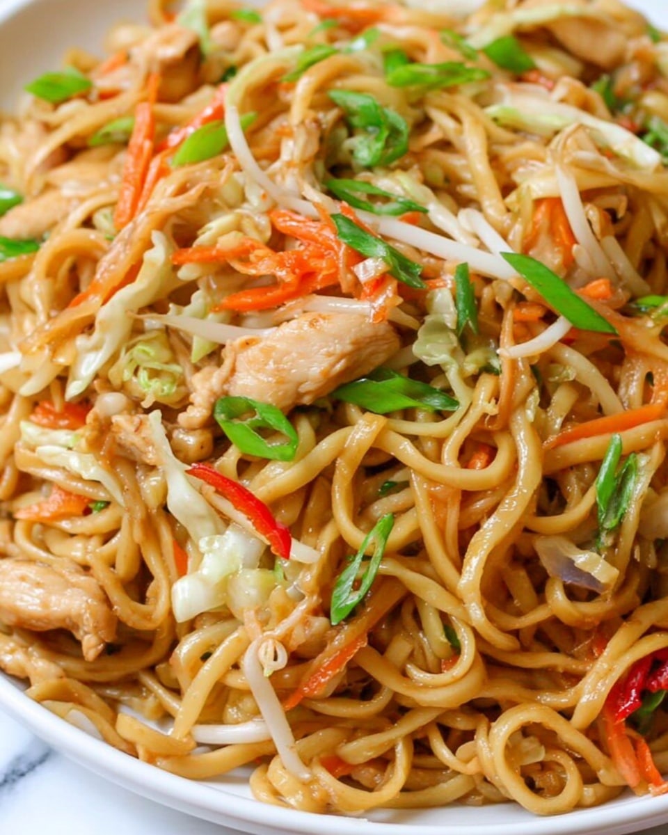 A close-up of a white bowl filled with three layers of food: the first layer is thick, yellowish-brown cooked noodles that look soft and tangled; the second layer includes small pieces of cooked chicken mixed with thin orange carrot strips and small bits of white cabbage; the top layer has green chopped scallions and small red chili slices sprinkled lightly to add color. The noodles shine slightly, showing a light glaze of sauce, and the background is a white marbled texture. Photo taken with an iphone --ar 4:5 --v 7
